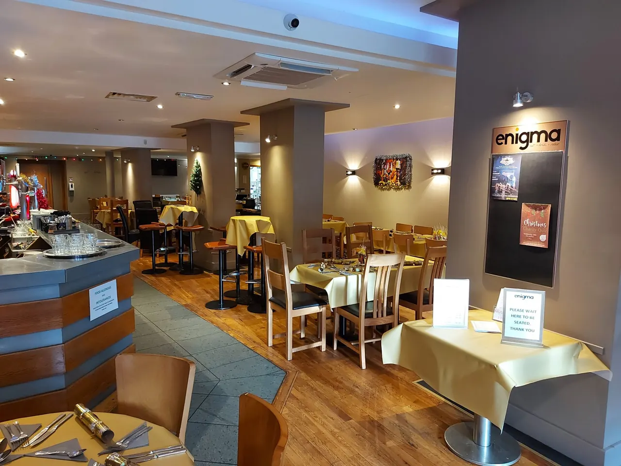 Enigma's dining room and bar with the illuminated Enigma sign in Market Harborough