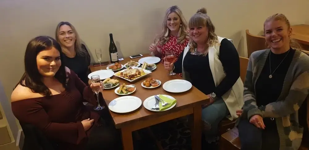 Friends dining together at Enigma